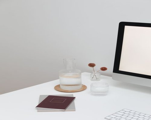 Water and notebook on a work desk