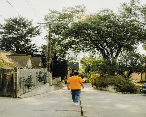 Person walking on a quiet urban street